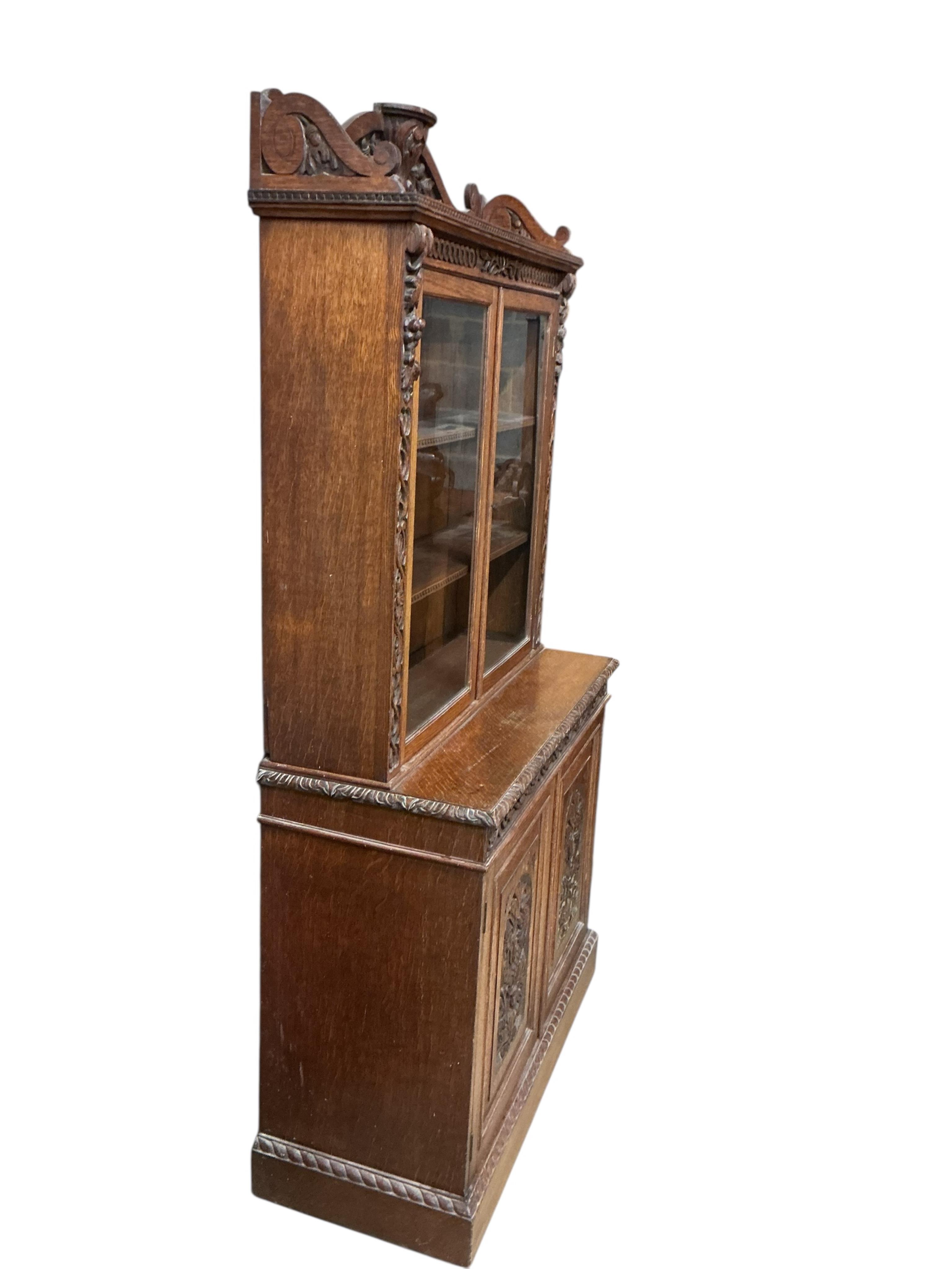A late Victorian carved oak bookcase, width 90cm, depth 39cm, height 180cm